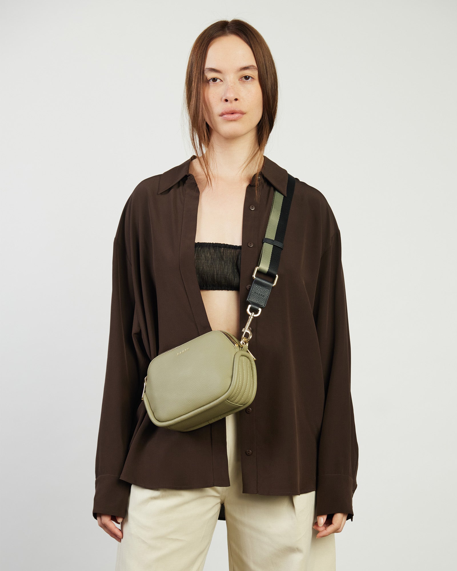 Green handbag with gold accents on a white background